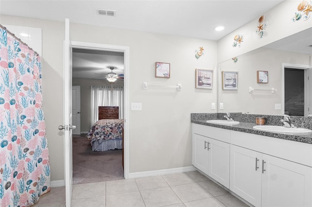 11303 Misty Moss Dr, Wimauma, FL 33598 - full bathroom with ensuite bathroom, double vanity, tile patterned floors, ceiling fan, and a shower with shower curtain