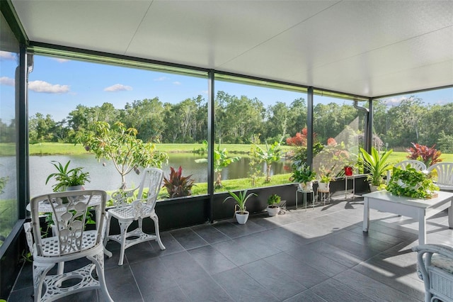 11303 Misty Moss Dr, Wimauma, FL 33598 - sunroom with view of wooded area, a water view, and tile patterned floors