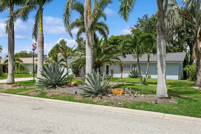 1304 63rd St NW, Bradenton, FL 34209 - view of property hidden behind natural elements with a front lawn