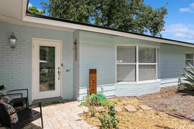 1304 63rd St NW, Bradenton, FL 34209 - doorway to property featuring brick siding