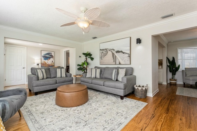1304 63rd St NW, Bradenton, FL 34209 - living room featuring crown molding, wood finished floors, ceiling fan, and a textured ceiling