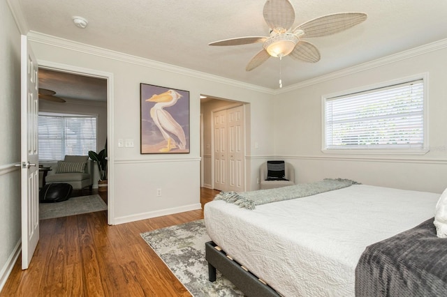 1304 63rd St NW, Bradenton, FL 34209 - bedroom featuring wood finished floors, ornamental molding, multiple windows, a closet, and a ceiling fan