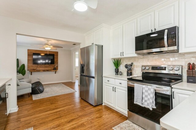 1304 63rd St NW, Bradenton, FL 34209 - kitchen featuring stainless steel appliances, ceiling fan, light countertops, white cabinetry, and ornamental molding