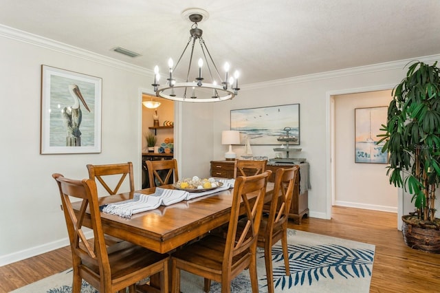 1304 63rd St NW, Bradenton, FL 34209 - dining space featuring a chandelier, wood finished floors, and ornamental molding