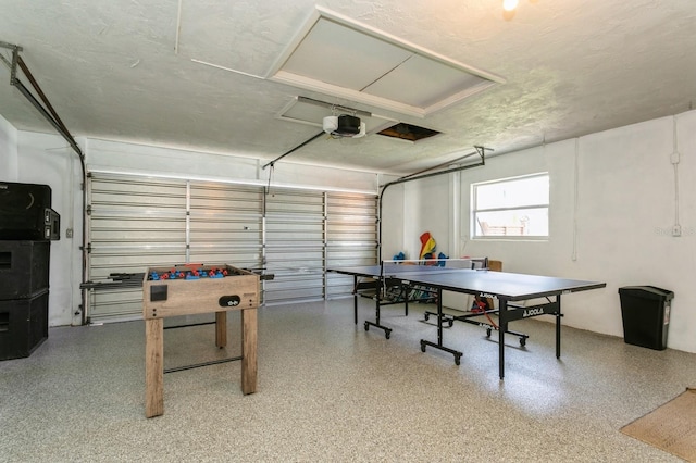1304 63rd St NW, Bradenton, FL 34209 - game room featuring a garage, speckled floor, and a textured ceiling