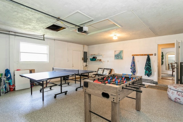 1304 63rd St NW, Bradenton, FL 34209 - rec room with attic access, electric panel, speckled floor, and a textured ceiling