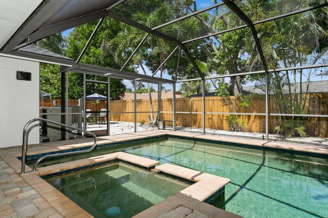 1304 63rd St NW, Bradenton, FL 34209 - view of swimming pool with a pool with connected hot tub, a fenced backyard, glass enclosure, and a patio area