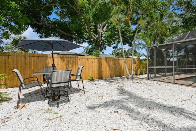 1304 63rd St NW, Bradenton, FL 34209 - fenced backyard with glass enclosure, a patio area, and outdoor dining area