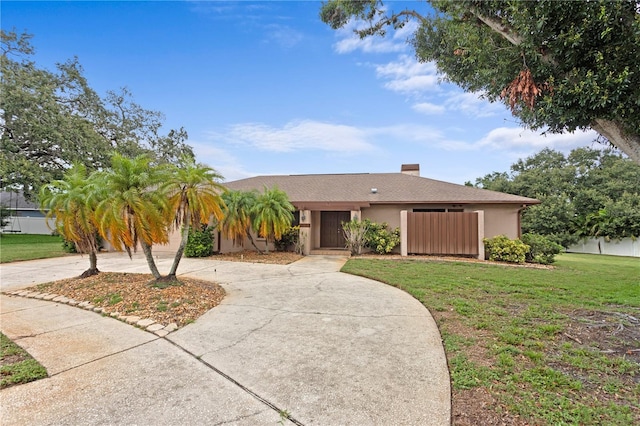 9311 136th Way, Seminole, FL 33776 - view of front facade with curved driveway, stucco siding, and a chimney