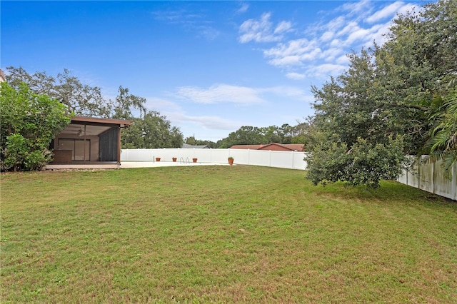 9311 136th Way, Seminole, FL 33776 - fenced backyard with a sunroom and a ceiling fan