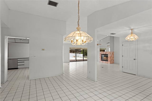 9311 136th Way, Seminole, FL 33776 - unfurnished dining area featuring a chandelier, high vaulted ceiling, a fireplace, and light tile patterned flooring