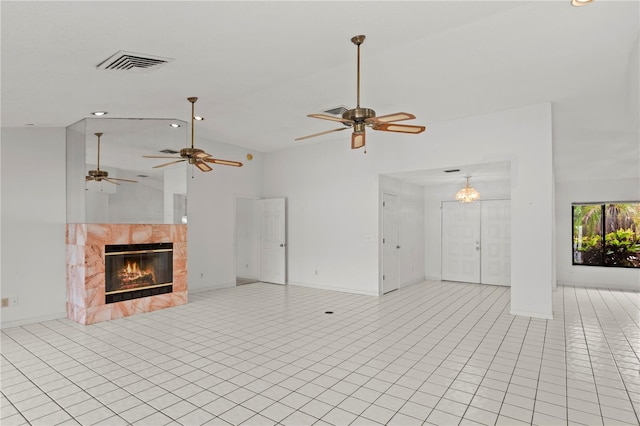 9311 136th Way, Seminole, FL 33776 - unfurnished living room featuring ceiling fan, a tile fireplace, light tile patterned flooring, and high vaulted ceiling