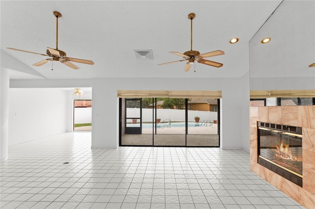 9311 136th Way, Seminole, FL 33776 - unfurnished living room featuring lofted ceiling, ceiling fan, a fireplace, recessed lighting, and light tile patterned floors