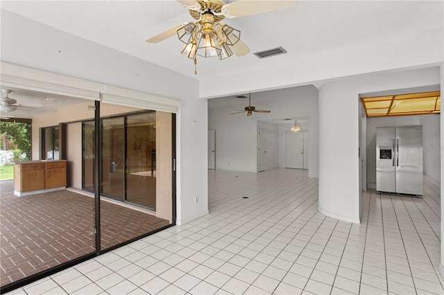 9311 136th Way, Seminole, FL 33776 - spare room featuring a ceiling fan and light tile patterned floors