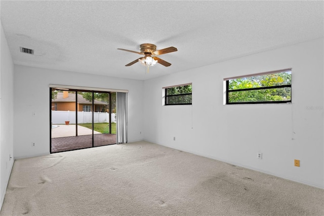 9311 136th Way, Seminole, FL 33776 - empty room featuring carpet, ceiling fan, and a textured ceiling