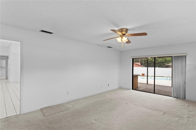 9311 136th Way, Seminole, FL 33776 - empty room featuring light carpet, ceiling fan, and a textured ceiling