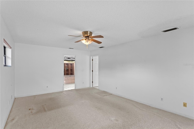 9311 136th Way, Seminole, FL 33776 - spare room featuring a ceiling fan, carpet, and a textured ceiling