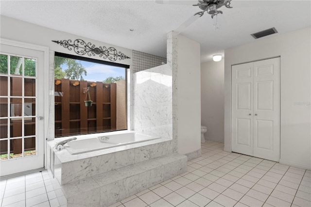 9311 136th Way, Seminole, FL 33776 - full bath featuring a garden tub, a closet, tile patterned flooring, and a ceiling fan