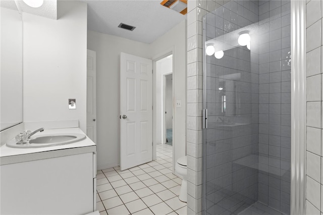 9311 136th Way, Seminole, FL 33776 - bathroom with vanity, a stall shower, tile patterned flooring, and a textured ceiling