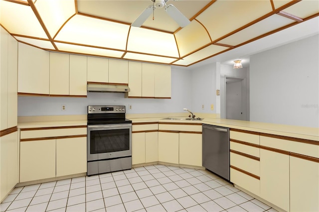 9311 136th Way, Seminole, FL 33776 - kitchen featuring appliances with stainless steel finishes, under cabinet range hood, cream cabinets, and light countertops
