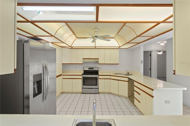 9311 136th Way, Seminole, FL 33776 - kitchen featuring stainless steel appliances, a peninsula, a ceiling fan, light countertops, and light tile patterned floors
