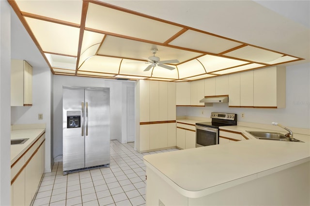 9311 136th Way, Seminole, FL 33776 - kitchen with appliances with stainless steel finishes, under cabinet range hood, light countertops, a peninsula, and light tile patterned floors