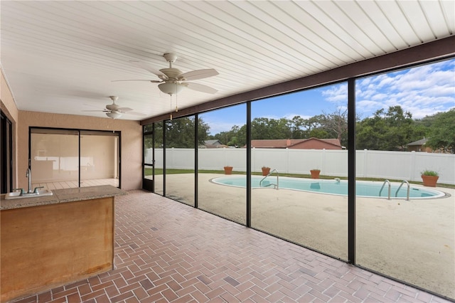 9311 136th Way, Seminole, FL 33776 - unfurnished sunroom with a sink and a pool