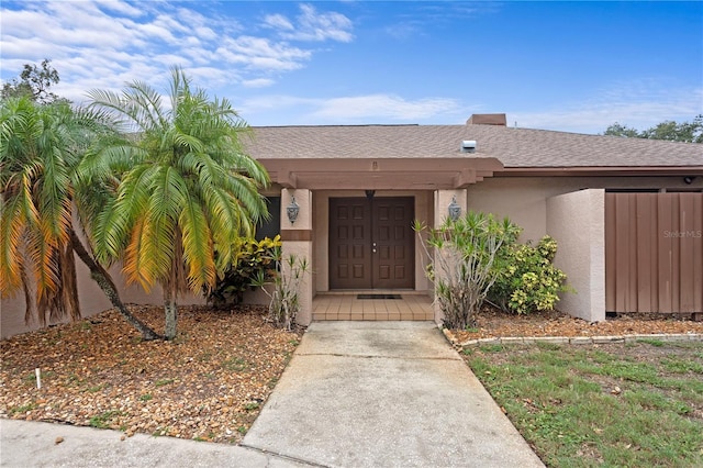 9311 136th Way, Seminole, FL 33776 - doorway to property with stucco siding