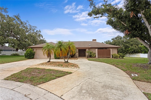 9311 136th Way, Seminole, FL 33776 - view of front of home with concrete driveway, a garage, stucco siding, and a chimney