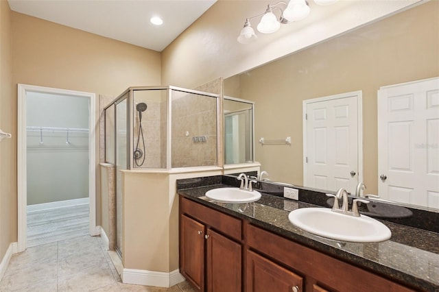 221 Sunset Crest Ct, Apollo Beach, FL 33572 - full bath featuring a stall shower, a spacious closet, double vanity, and tile patterned flooring