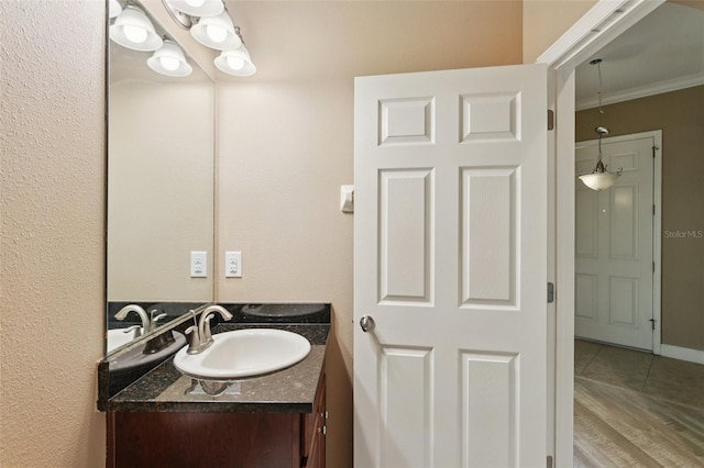 221 Sunset Crest Ct, Apollo Beach, FL 33572 - bathroom with vanity, ornamental molding, and wood finished floors