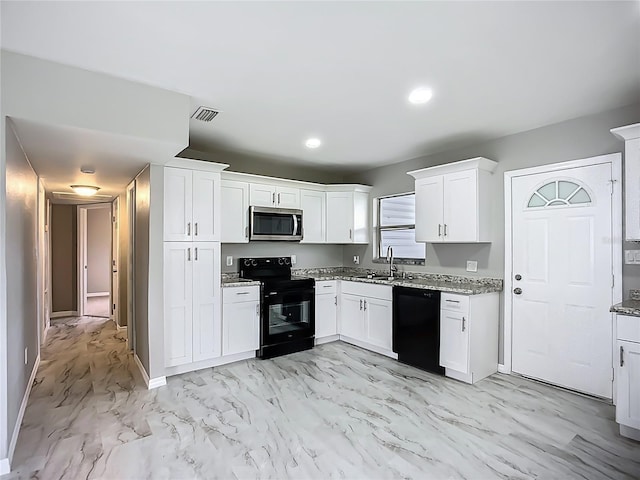 6228 Florida Cir W, Apollo Beach, FL 33572 - kitchen with black appliances, light stone countertops, light marble finish floors, white cabinets, and recessed lighting