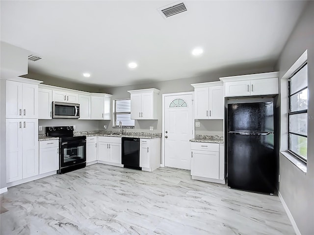 6228 Florida Cir W, Apollo Beach, FL 33572 - kitchen featuring black appliances, light marble finish flooring, white cabinets, light stone counters, and recessed lighting