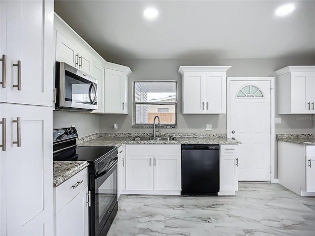 6228 Florida Cir W, Apollo Beach, FL 33572 - kitchen featuring black appliances, white cabinets, light stone counters, light marble finish floors, and recessed lighting