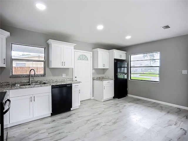 6228 Florida Cir W, Apollo Beach, FL 33572 - kitchen featuring black appliances, light marble finish floors, light stone countertops, white cabinetry, and healthy amount of natural light