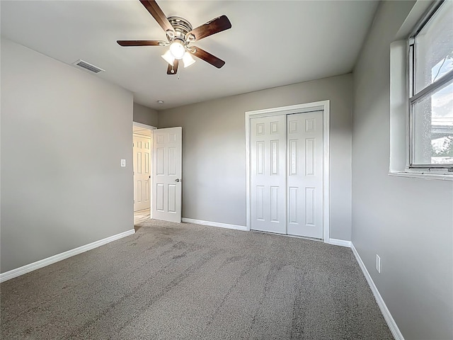 6228 Florida Cir W, Apollo Beach, FL 33572 - unfurnished bedroom with carpet, a closet, and ceiling fan