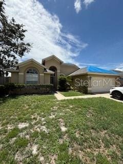 8902 Breland Dr, Tampa, FL 33626 - view of front facade with a front yard and stucco siding