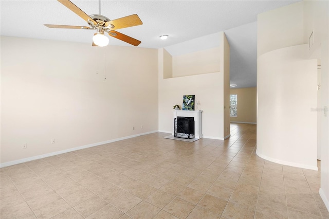 2231 Utopian Dr E Unit 307, Clearwater, FL 33763 - unfurnished living room featuring light tile patterned floors, ceiling fan, a fireplace with raised hearth, and high vaulted ceiling