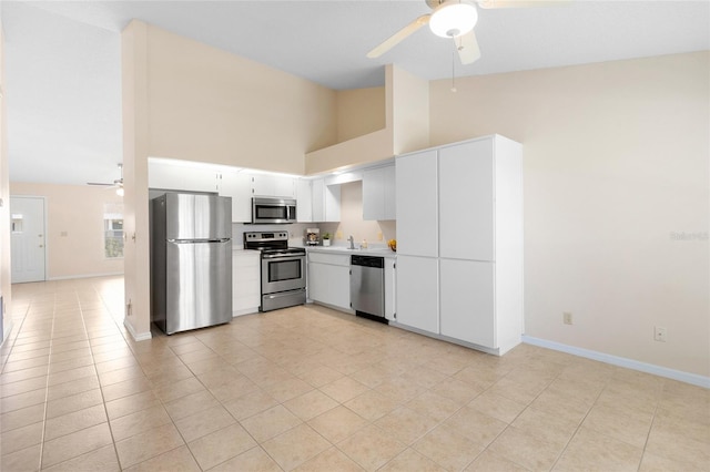 2231 Utopian Dr E Unit 307, Clearwater, FL 33763 - kitchen featuring appliances with stainless steel finishes, ceiling fan, light countertops, high vaulted ceiling, and light tile patterned floors