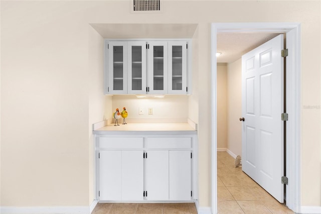 2231 Utopian Dr E Unit 307, Clearwater, FL 33763 - bar area with light tile patterned flooring and baseboards