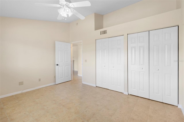 2231 Utopian Dr E Unit 307, Clearwater, FL 33763 - unfurnished bedroom with two closets, high vaulted ceiling, and ceiling fan