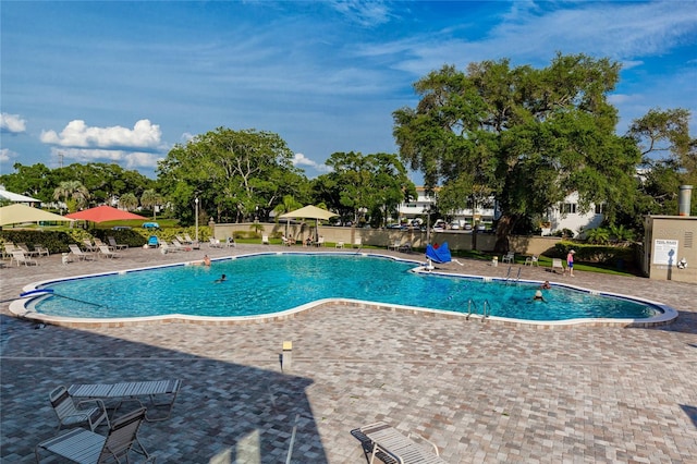 2231 Utopian Dr E Unit 307, Clearwater, FL 33763 - community pool featuring a patio area