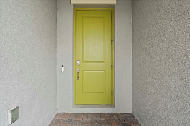 22034 Storybook Cabin Way, Land O Lakes, FL 34637 - doorway to property featuring stucco siding