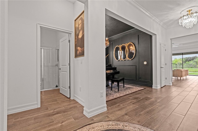 22034 Storybook Cabin Way, Land O Lakes, FL 34637 - hall featuring a chandelier, wood finished floors, and crown molding