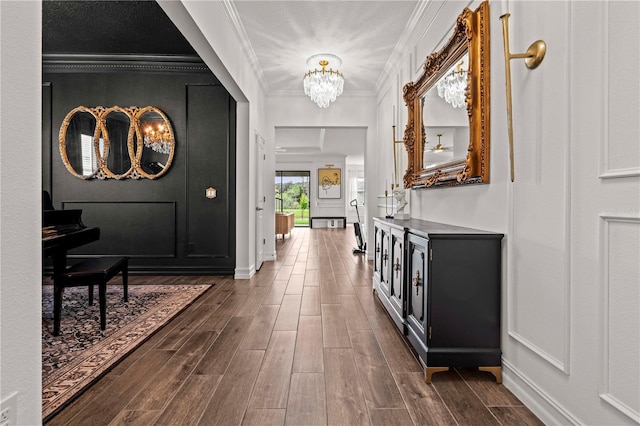 22034 Storybook Cabin Way, Land O Lakes, FL 34637 - hallway with a chandelier, dark wood-type flooring, and crown molding