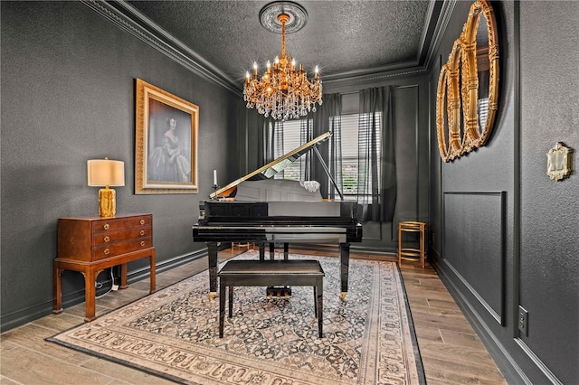 22034 Storybook Cabin Way, Land O Lakes, FL 34637 - living area featuring crown molding, wood finished floors, a chandelier, a textured ceiling, and a textured wall