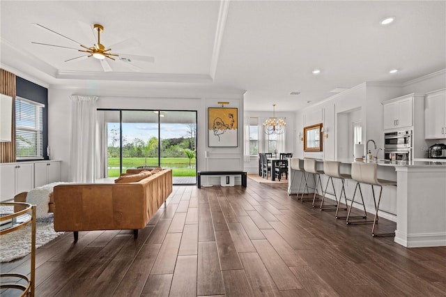 22034 Storybook Cabin Way, Land O Lakes, FL 34637 - living room with plenty of natural light, dark wood-style flooring, ornamental molding, a raised ceiling, and recessed lighting