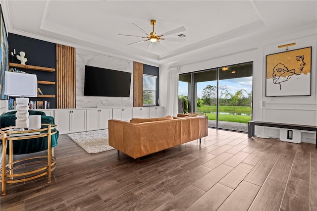 22034 Storybook Cabin Way, Land O Lakes, FL 34637 - living area featuring a tray ceiling, a ceiling fan, wood finished floors, and ornamental molding