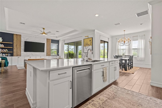 22034 Storybook Cabin Way, Land O Lakes, FL 34637 - kitchen featuring stainless steel dishwasher, wood finished floors, a chandelier, and an island with sink