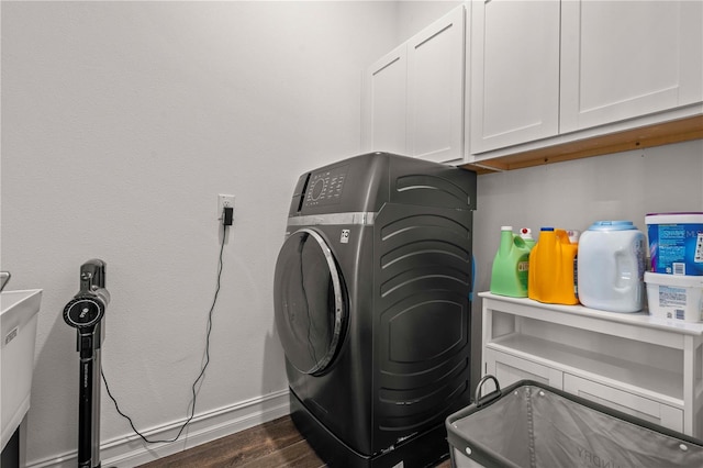 22034 Storybook Cabin Way, Land O Lakes, FL 34637 - laundry area featuring washer / dryer, cabinet space, and dark wood-style flooring